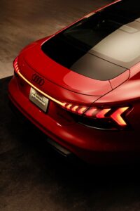 A red car is parked in a garage